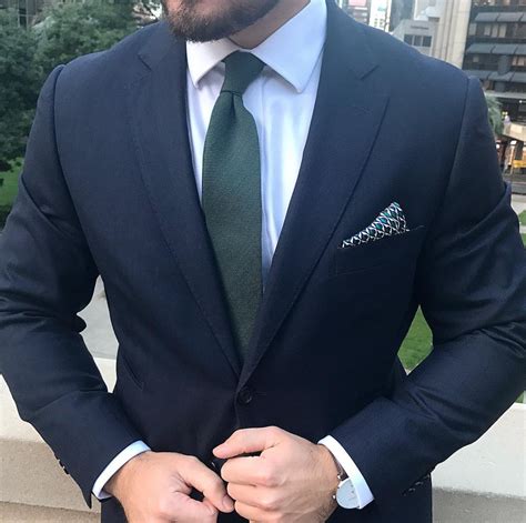 green tie with navy suit.